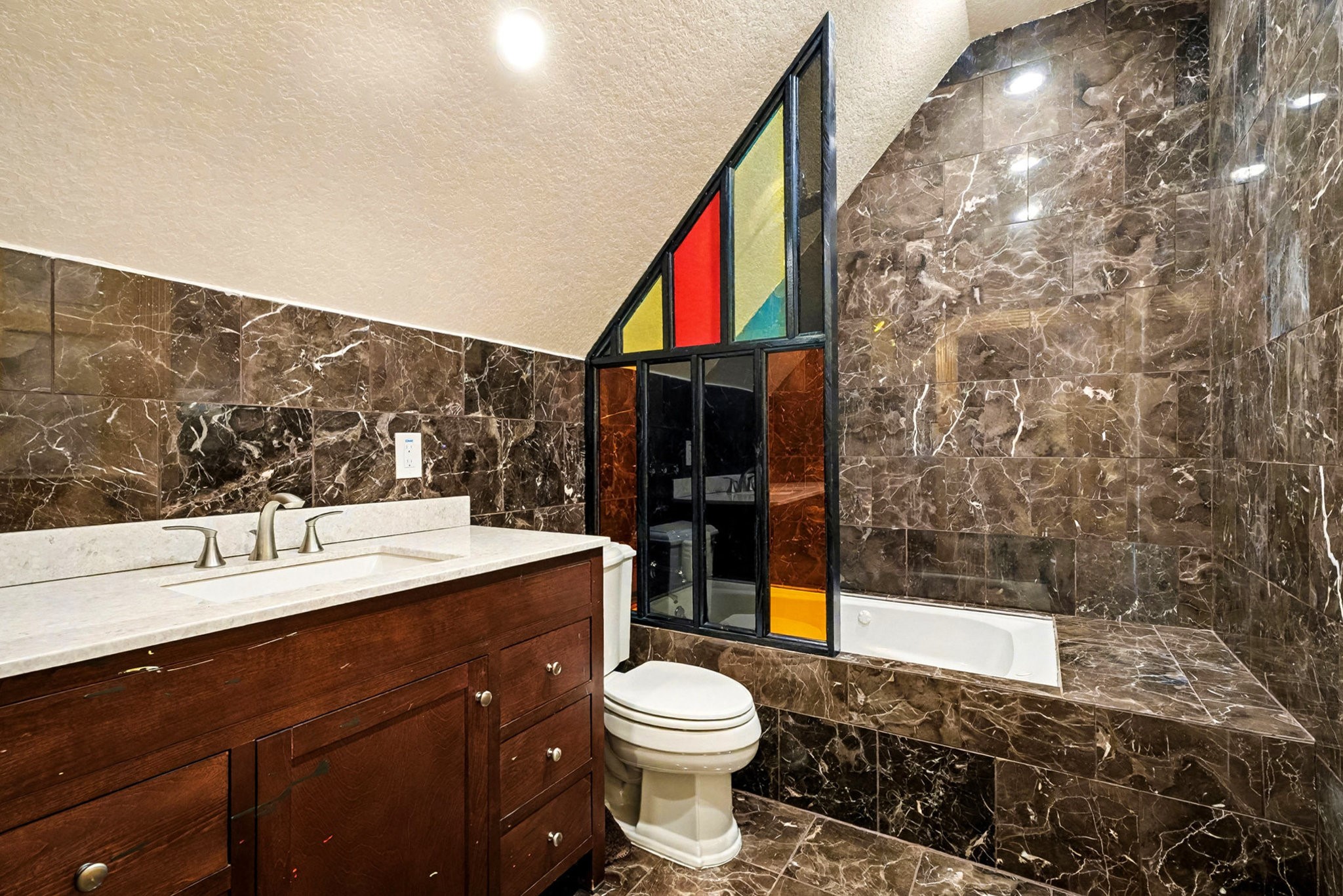 1200 Davenport Parkway Rosharon, TX 77583 - Photo 29 of 49 Elegantly tiled second-floor guest room (2) (east end), bathroom with marble finishes, a soaking tub, and a vibrant
custom stained-glass window.