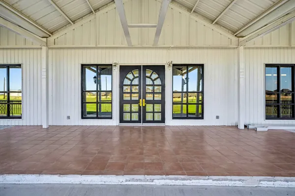 a living room with lots of furniture and a large window
