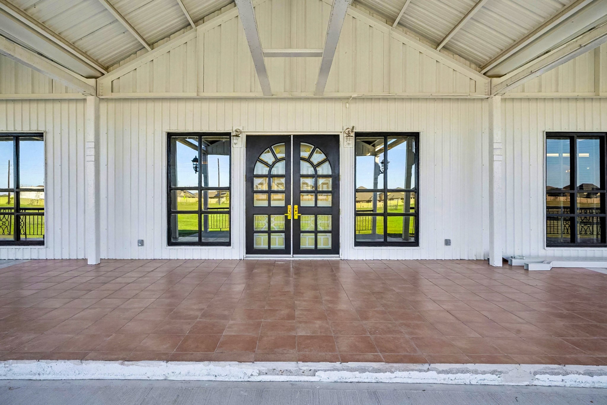 1200 Davenport Parkway Rosharon, TX 77583 - Photo 3 of 49 1208 sqft spacious covered porch with double doors and large windows.