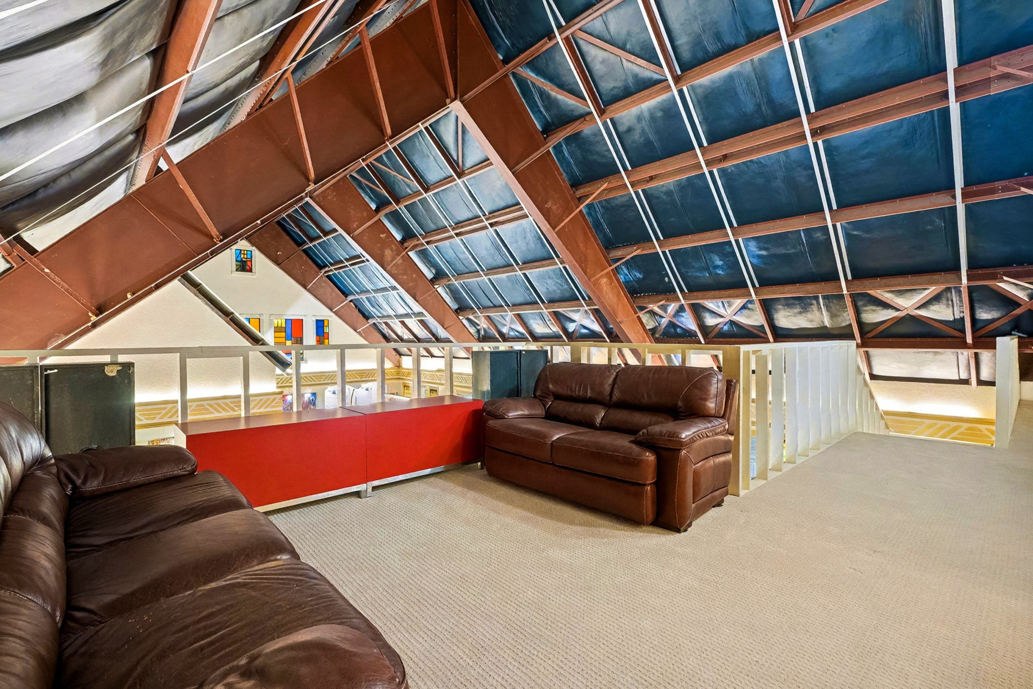 1200 Davenport Parkway Rosharon, TX 77583 - Photo 30 of 49 Upstairs on third floor (East end) loft living space with open beam ceiling, cozy leather seating, and a view
overlooking the main level.