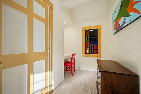 a view of a livingroom with workspace and a window