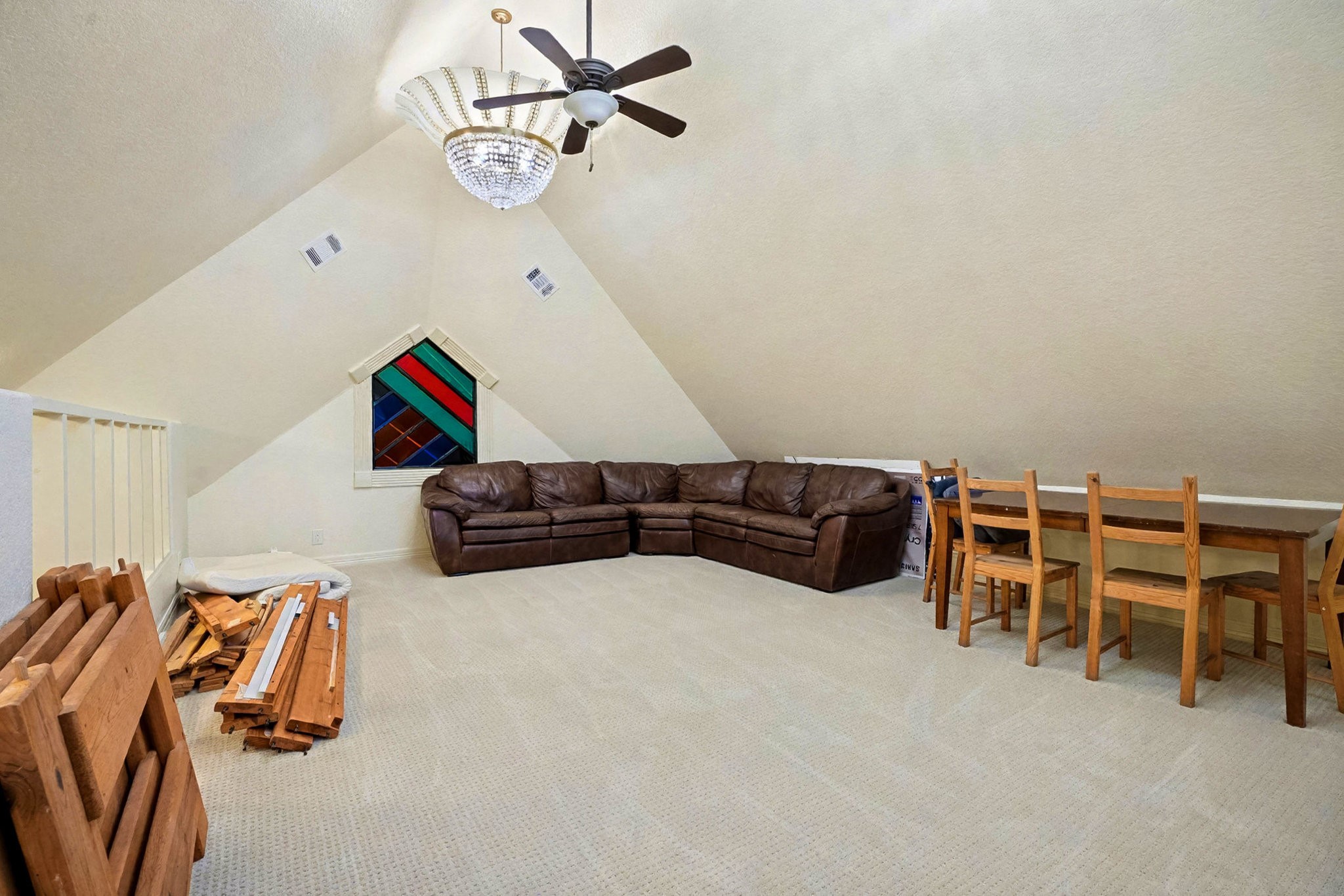 1200 Davenport Parkway Rosharon, TX 77583 - Photo 35 of 49 Third-floor guest room (4) (east end) on the left side of the home featuring vaulted ceilings, a
crystal chandelier, and cozy seating beneath a custom stained-glass window.