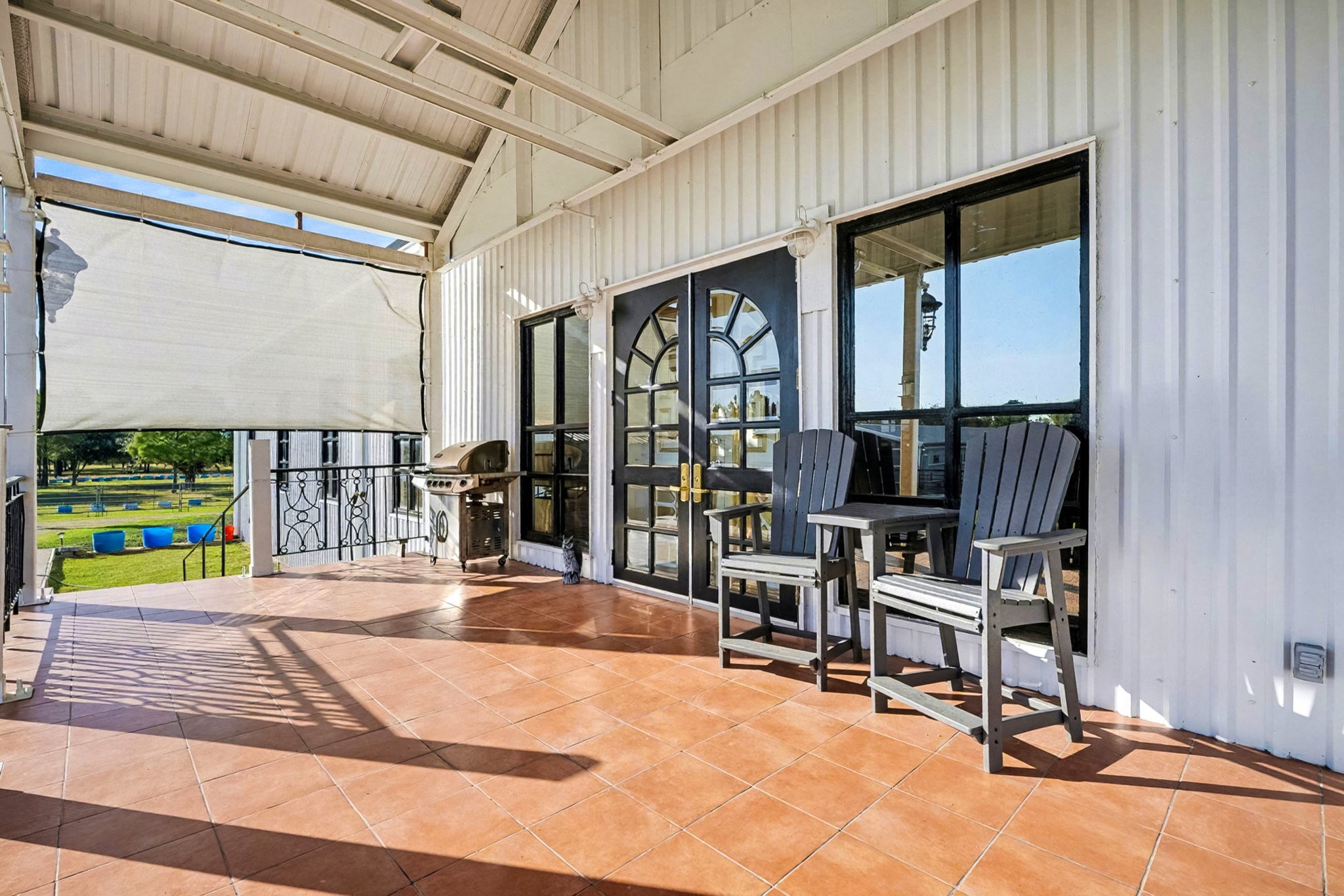 1200 Davenport Parkway Rosharon, TX 77583 - Photo 40 of 49 Spacious back porch featuring warm terra-cotta tile flooring and custom-made double
doors with arched glass panes—perfect for relaxing or entertaining while overlooking the
peaceful grounds.