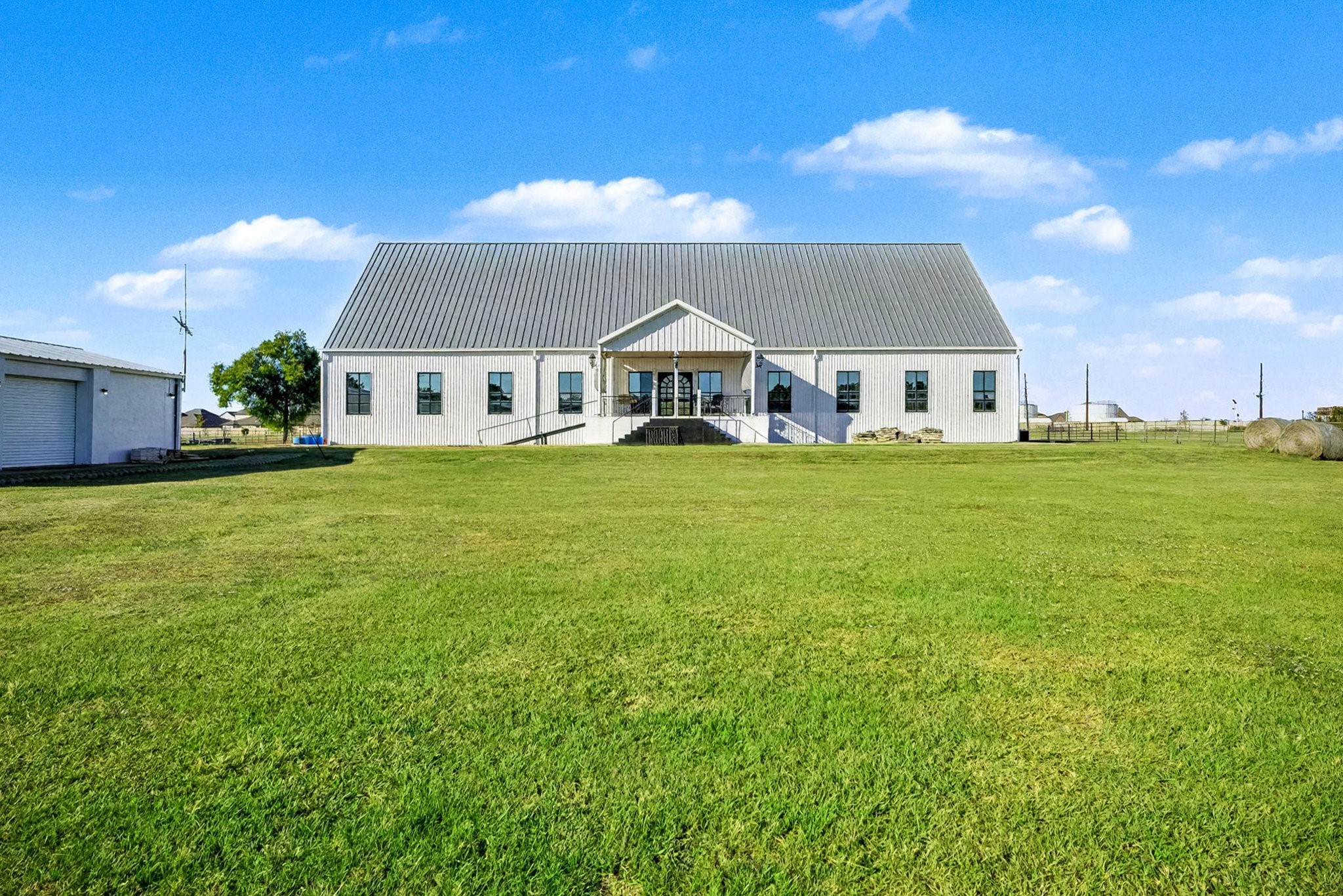 1200 Davenport Parkway Rosharon, TX 77583 - Photo 41 of 49 Expansive back view of the home nestled on 3.5 acres, displaying its impressive architectural style metal
roof and wide-open lawn. The second angle highlights the detached garage.
perfectly complementing the property’s spacious, functional layout.