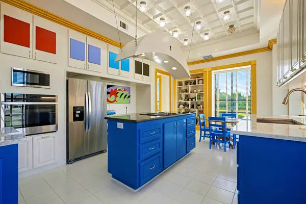 a kitchen with stainless steel appliances granite countertop a refrigerator and a stove