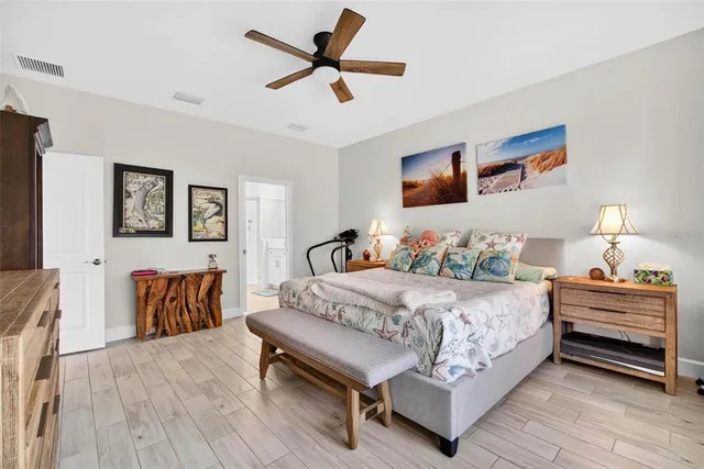 a bedroom with a bed and a flat tv screen on dresser
