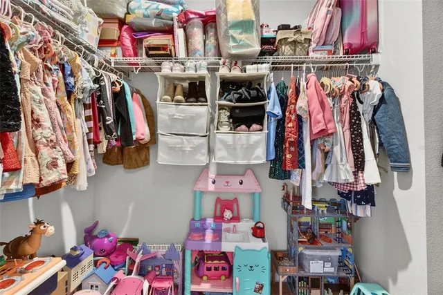 a living room with furniture a rug and a floor to ceiling window