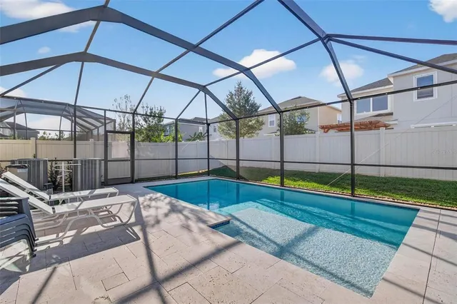 a view of a house with backyard and sitting area