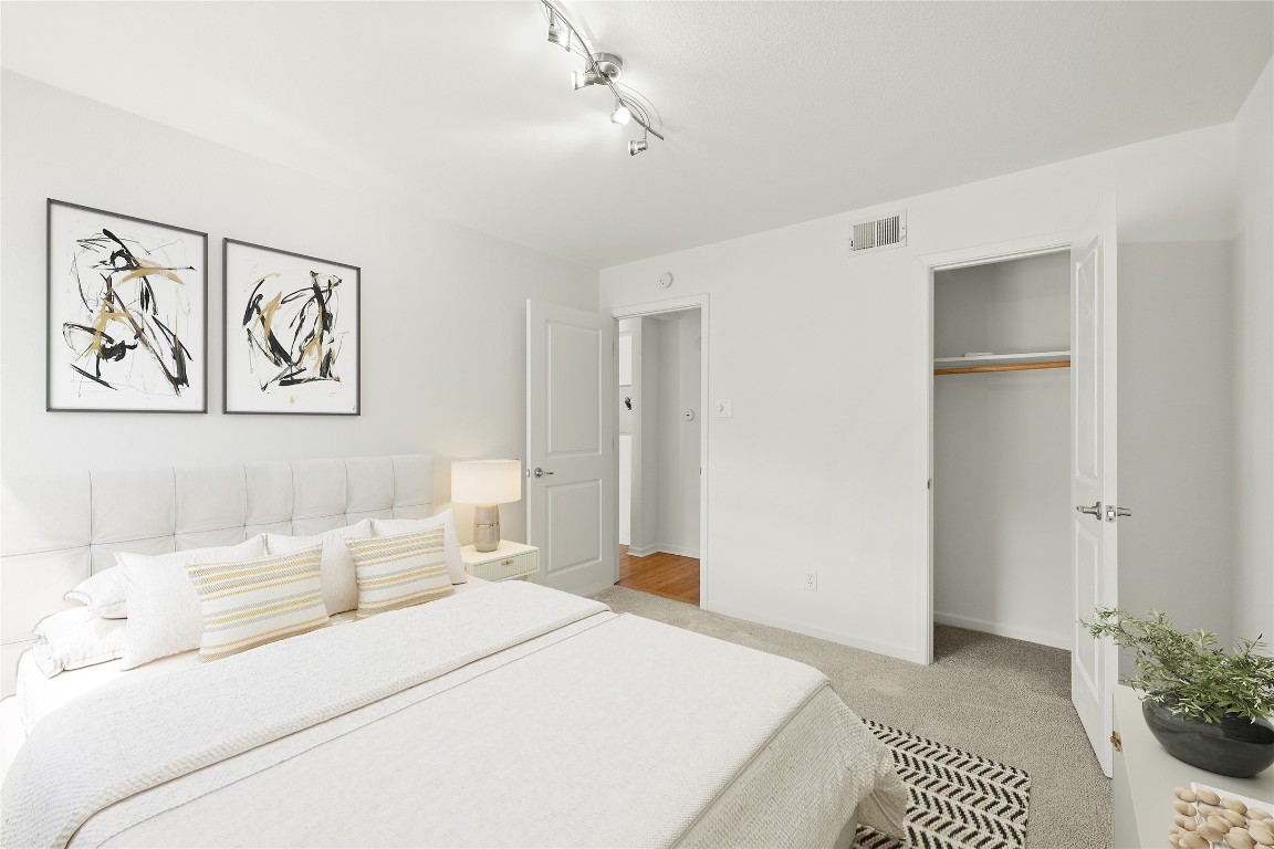 3204 Menchaca Road, Unit 216 Austin, TX 78704 - Photo 19 of 38 a bedroom with a bed and a painting on the wall