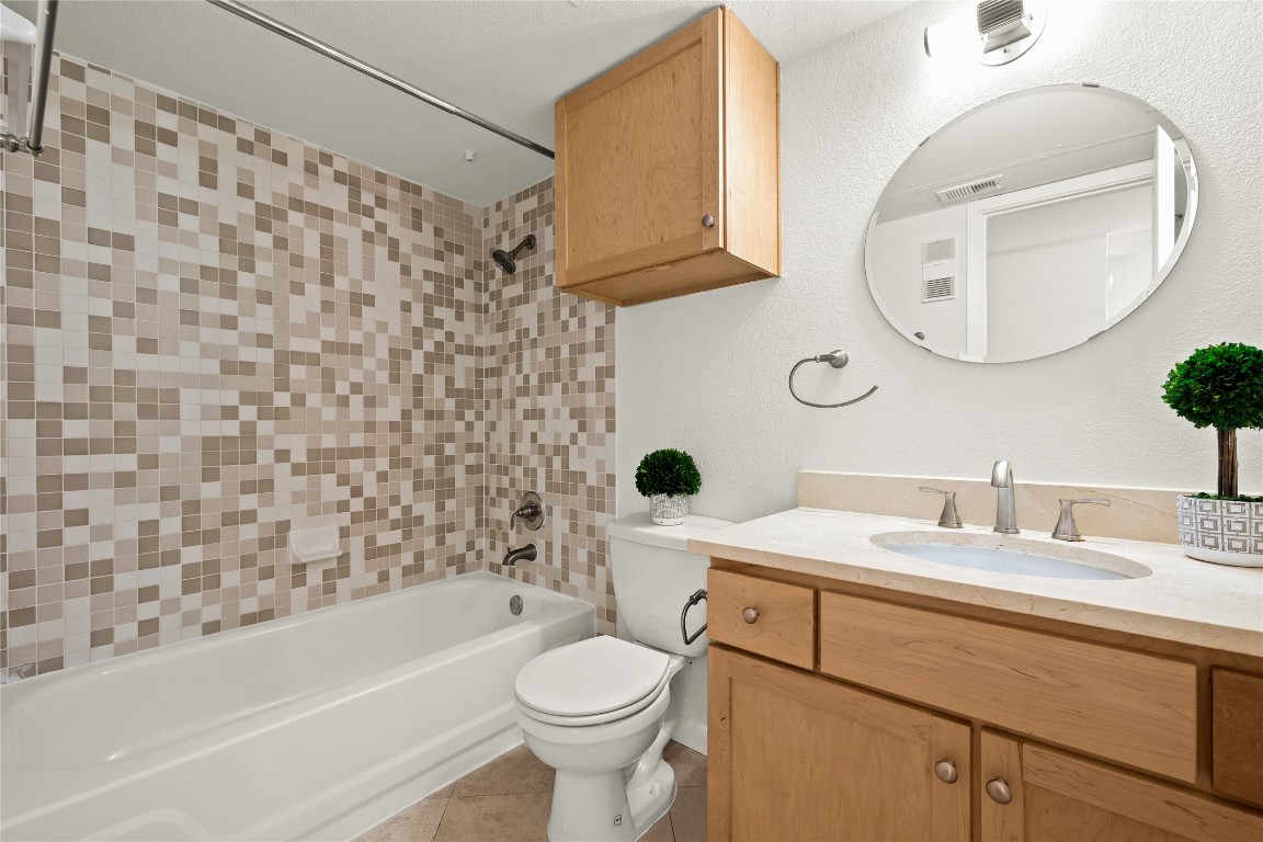 3204 Menchaca Road, Unit 216 Austin, TX 78704 - Photo 20 of 38 a bathroom with a sink a toilet and a mirror