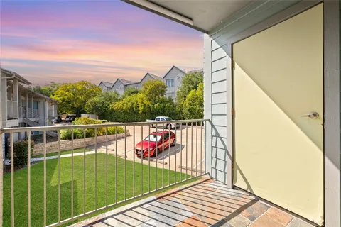 a view of balcony with wooden floor