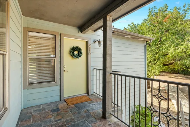 a view of a porch with a door and wooden floor