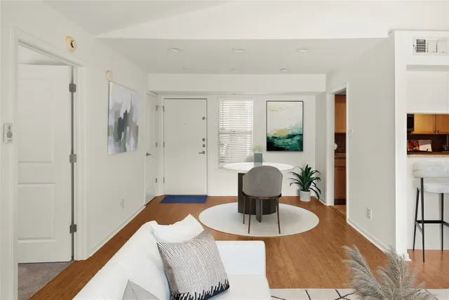 a living room with furniture and a potted plant