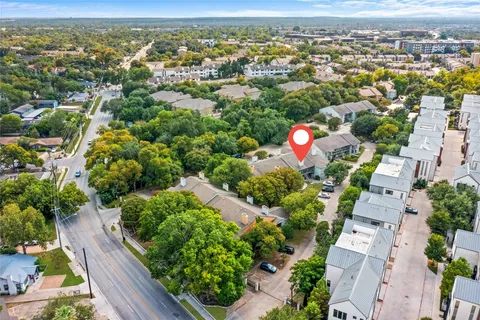 an aerial view of residential houses with outdoor space and street view