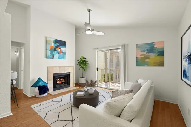 a living room with furniture and a fireplace with wooden floor