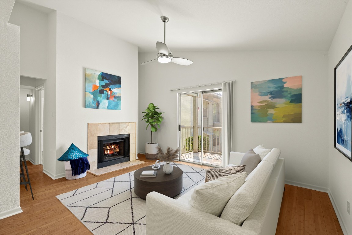 3204 Menchaca Road, Unit 216 Austin, TX 78704 - Photo 5 of 38 a living room with furniture and a fireplace with wooden floor