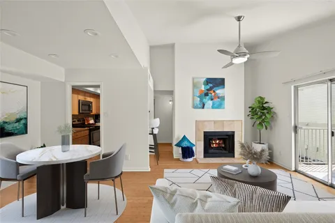 a living room with furniture a fireplace and a table