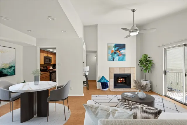 a living room with furniture a fireplace and a table