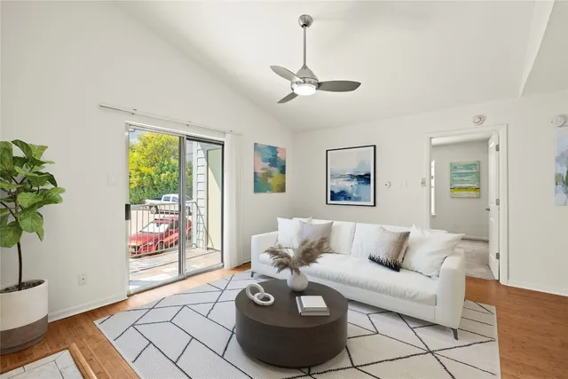 a living room with furniture and a potted plant