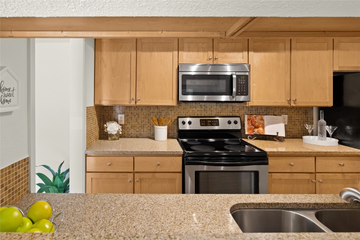3204 Menchaca Road, Unit 216 Austin, TX 78704 - Photo 10 of 38 a kitchen with stainless steel appliances a stove a sink and a microwave