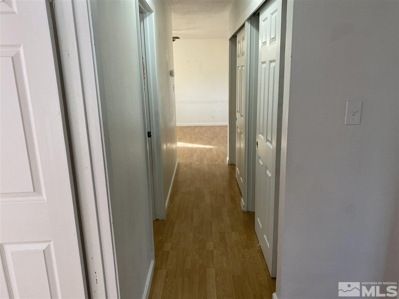 1165 Manhattan Street Reno, NV 89512 - Photo 11 of 14 a view of a hallway with wooden floor