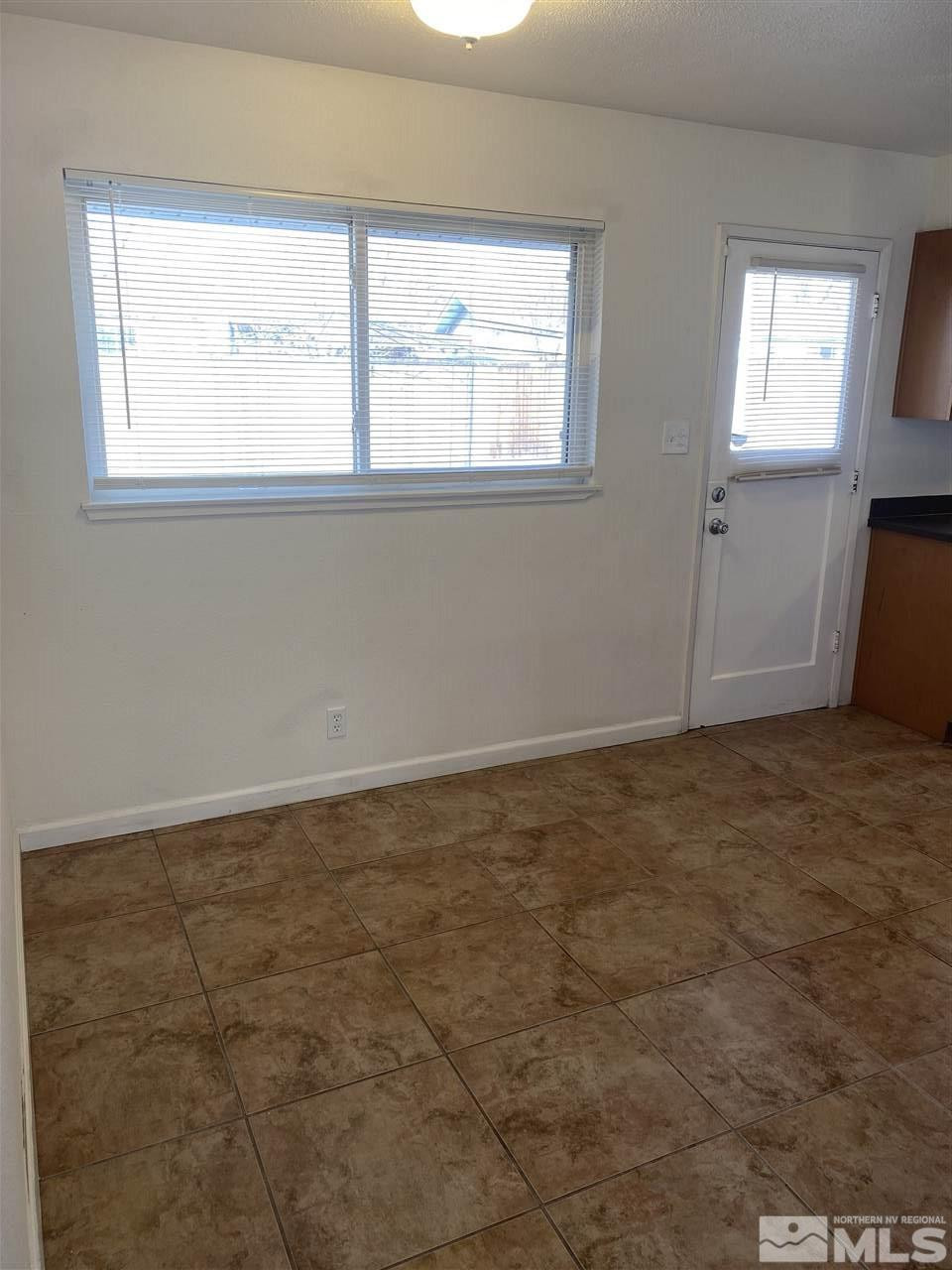 1165 Manhattan Street Reno, NV 89512 - Photo 3 of 14 an empty room with a window