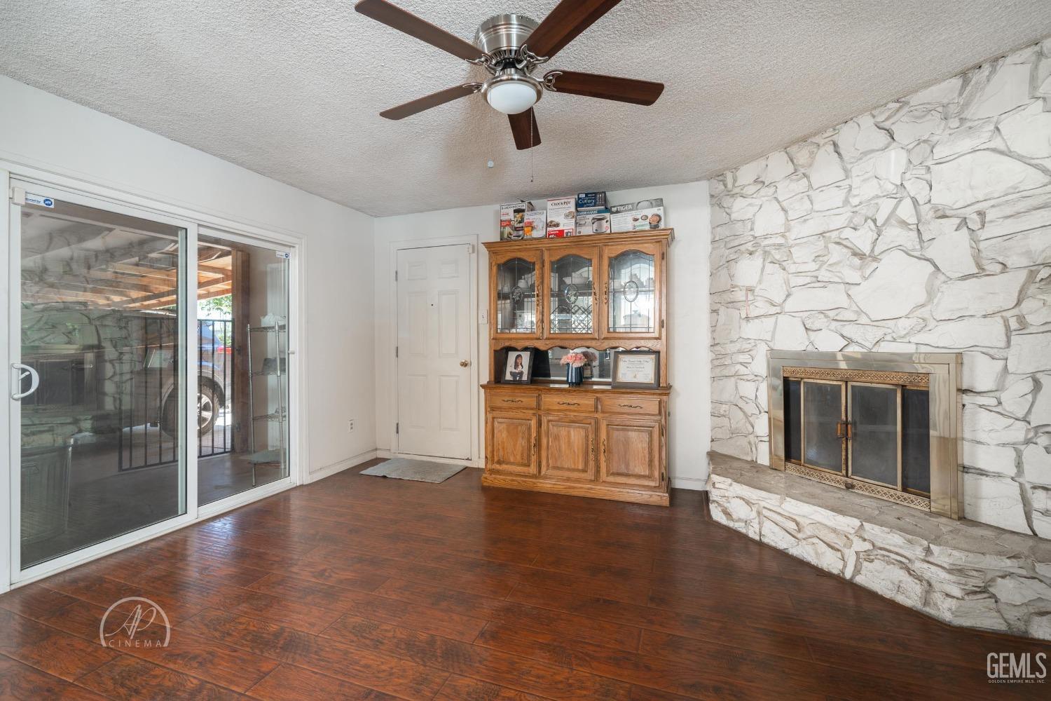Undisclosed Address Bakersfield, CA 93307 - Photo 14 of 26 a view of a livingroom with a fireplace and window