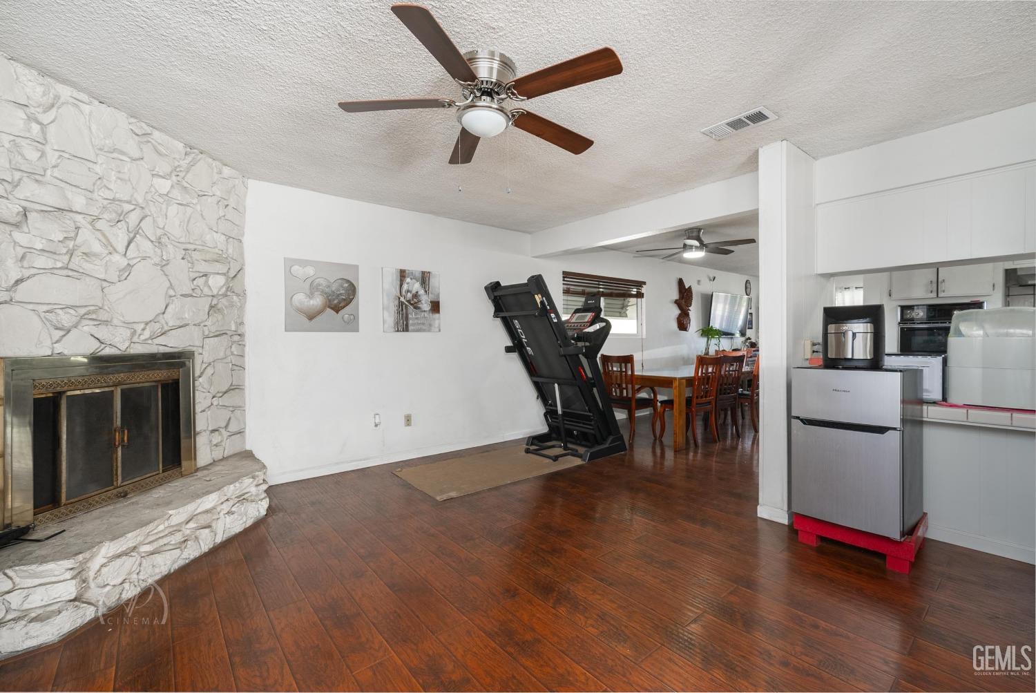 Undisclosed Address Bakersfield, CA 93307 - Photo 15 of 26 a view of a workspace with furniture and a fireplace