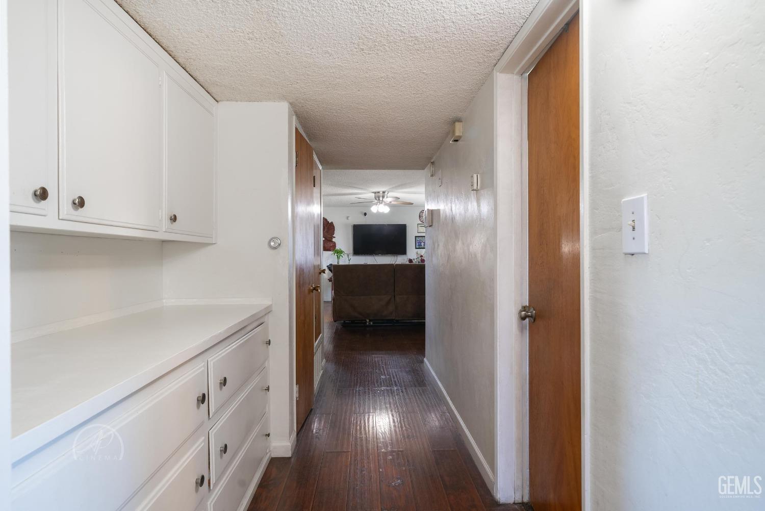Undisclosed Address Bakersfield, CA 93307 - Photo 16 of 26 a view of a hallway view with wooden floor and cabinets