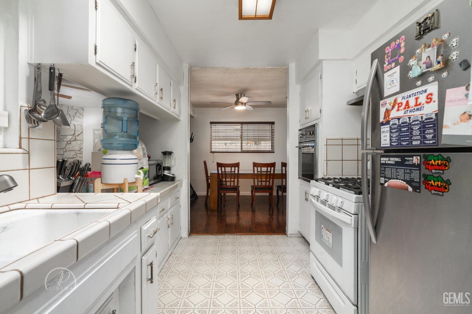 Undisclosed Address Bakersfield, CA 93307 - Photo 19 of 26 a kitchen with a sink stove and cabinets