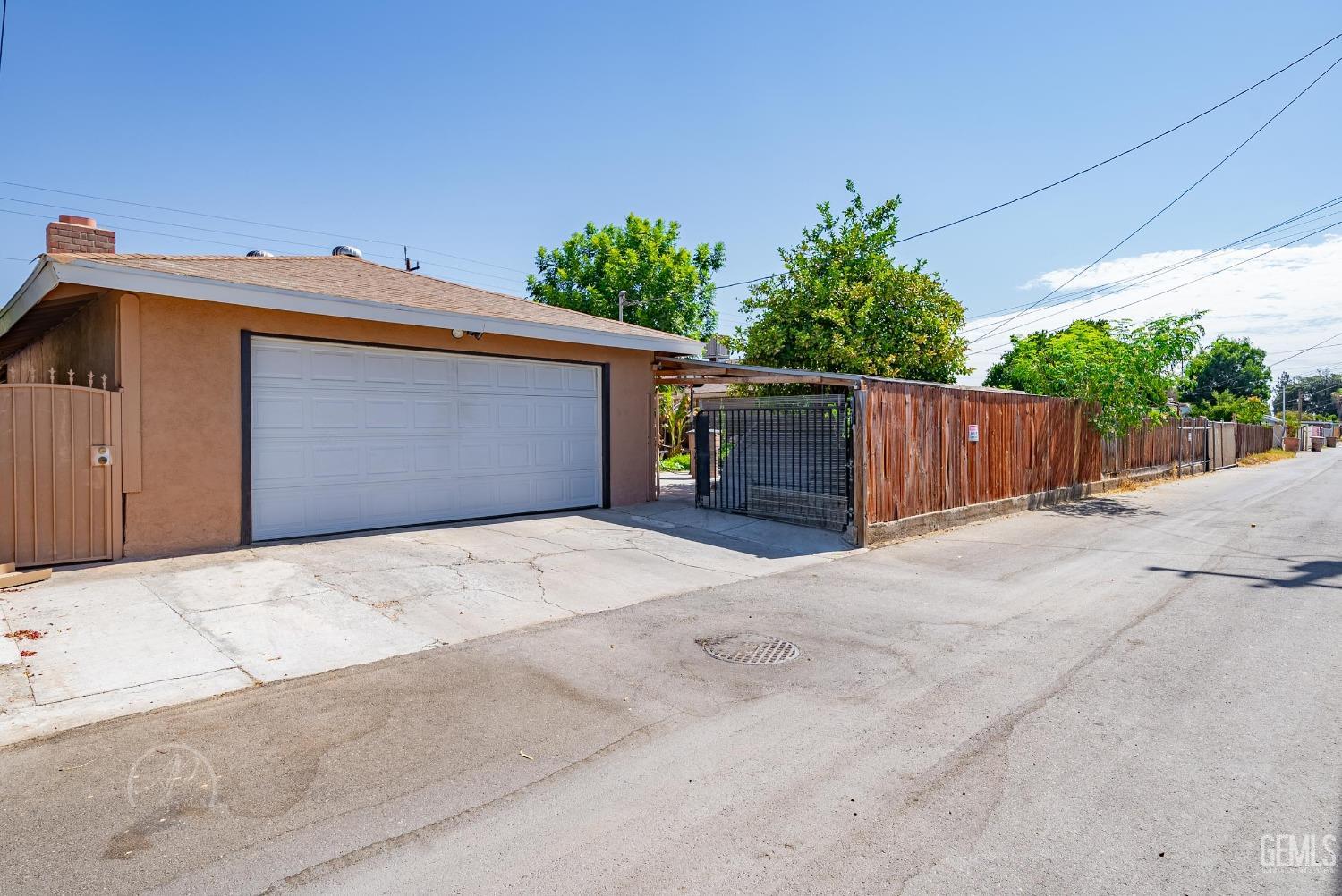 Undisclosed Address Bakersfield, CA 93307 - Photo 26 of 26 a front view of a house with a yard and garage