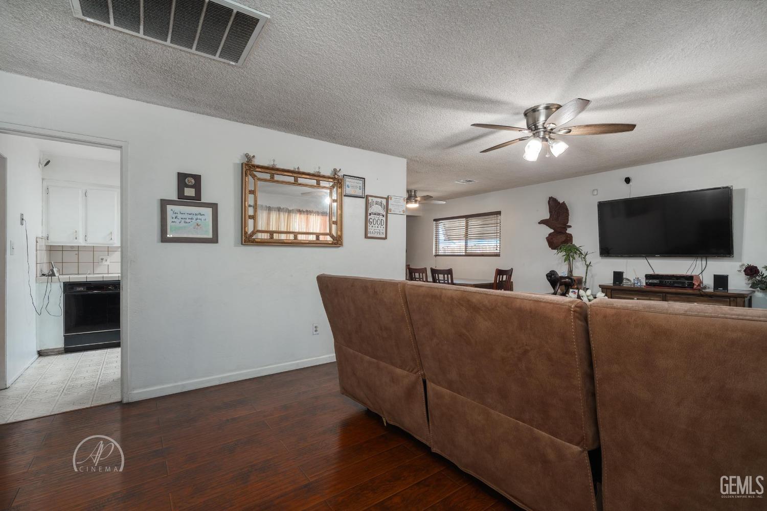 Undisclosed Address Bakersfield, CA 93307 - Photo 4 of 26 a living room with furniture and a flat screen tv