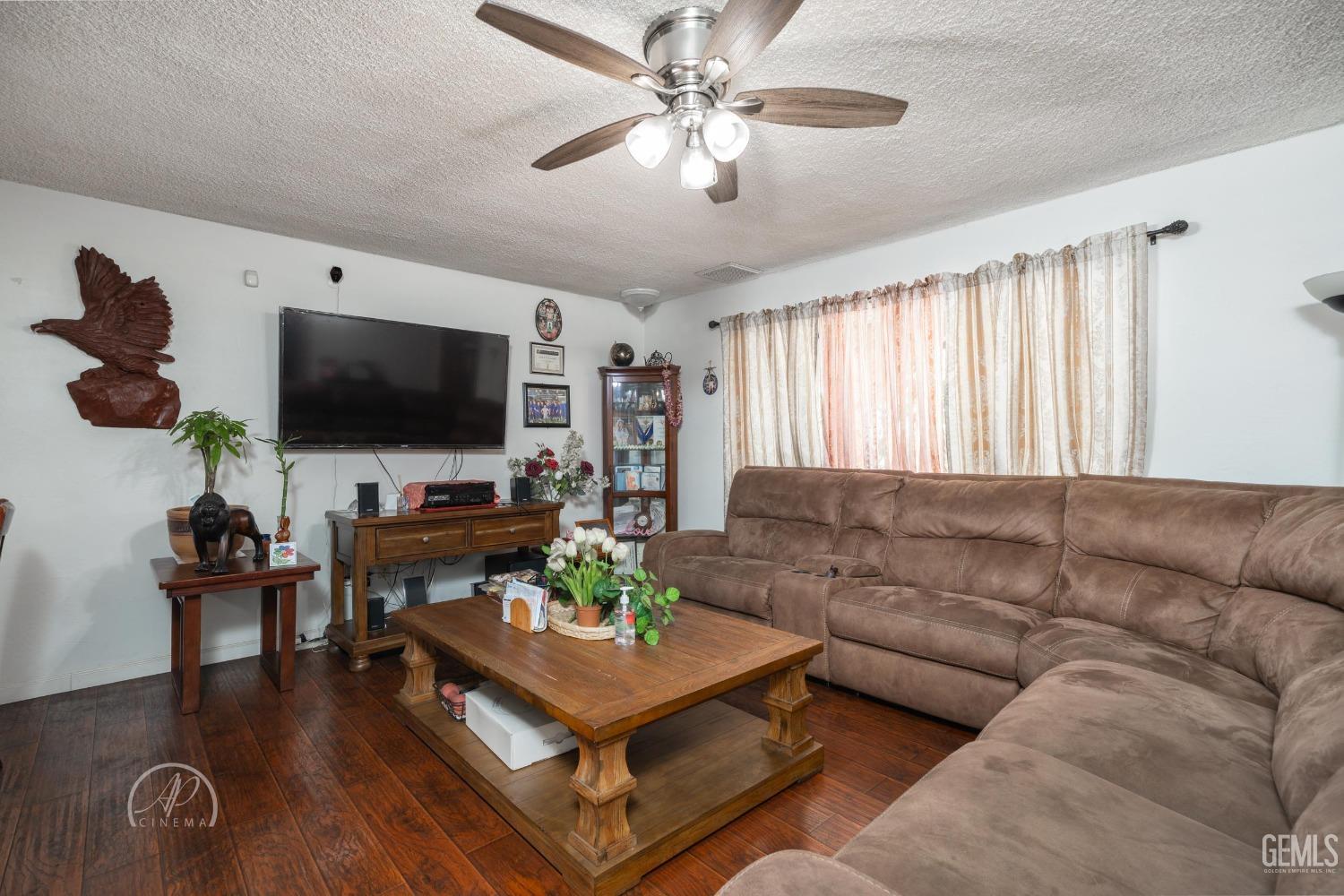 Undisclosed Address Bakersfield, CA 93307 - Photo 5 of 26 a living room with furniture and a flat screen tv