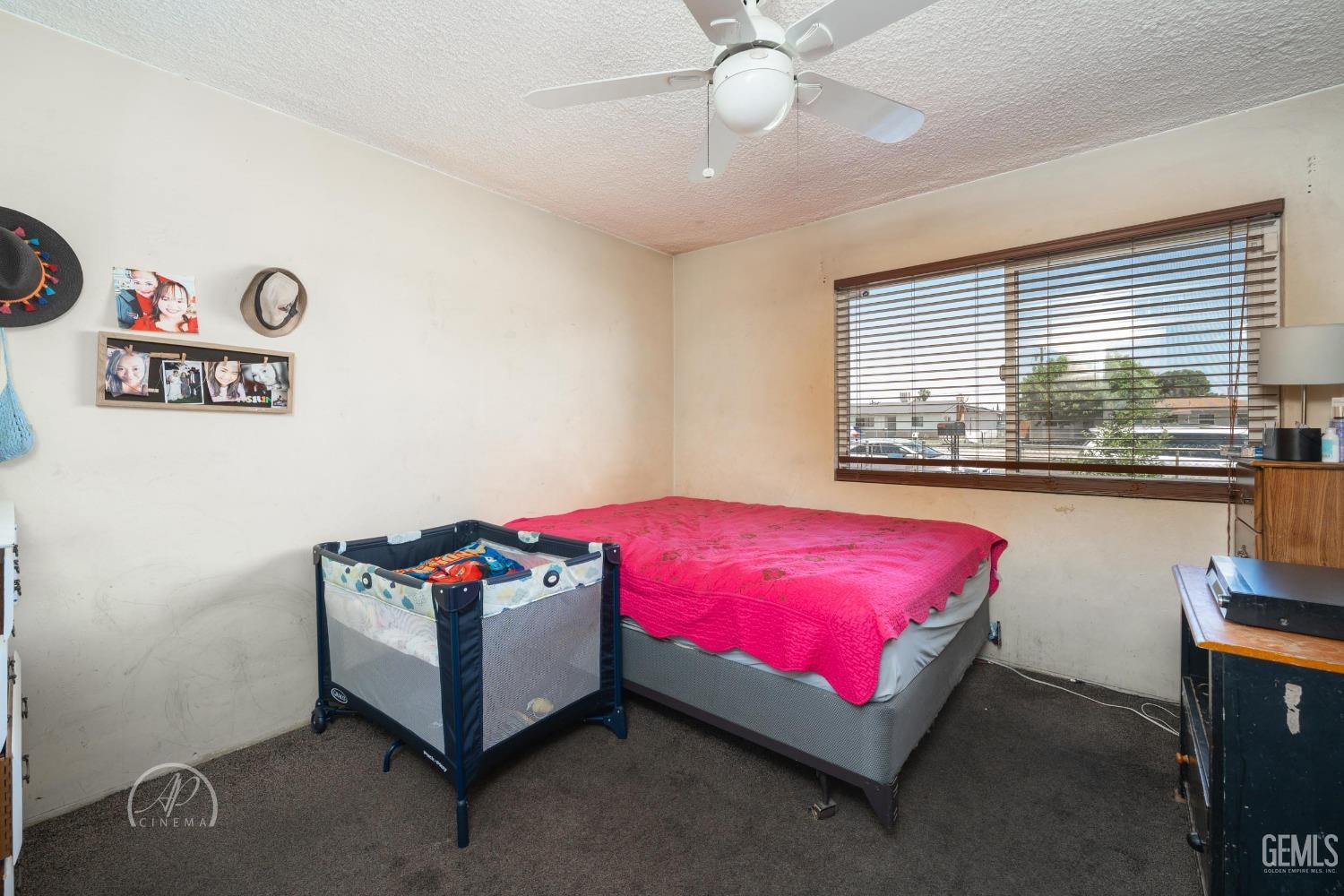 Undisclosed Address Bakersfield, CA 93307 - Photo 7 of 26 a bedroom with a bed and window