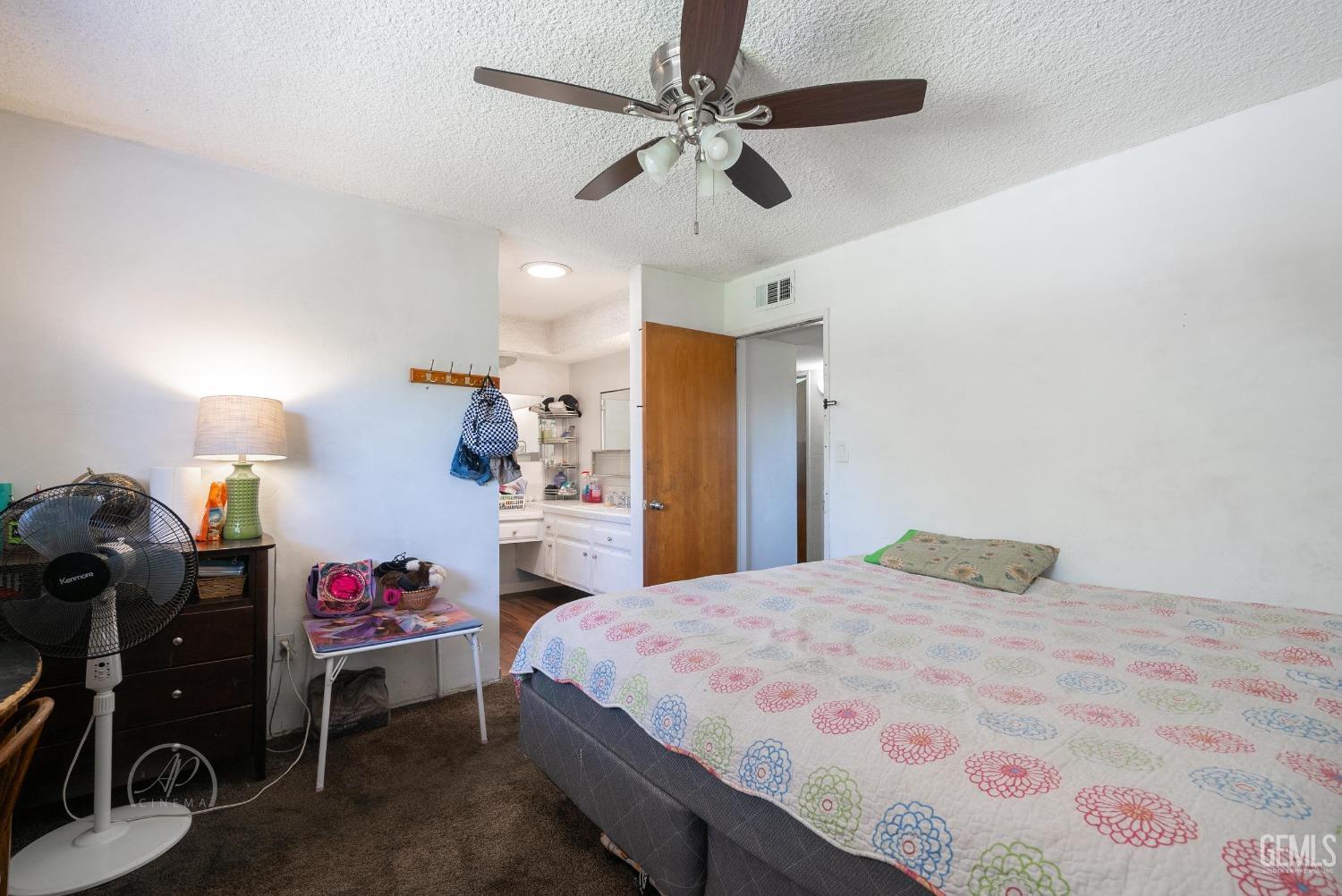 Undisclosed Address Bakersfield, CA 93307 - Photo 8 of 26 a bedroom with a bed and a chandelier