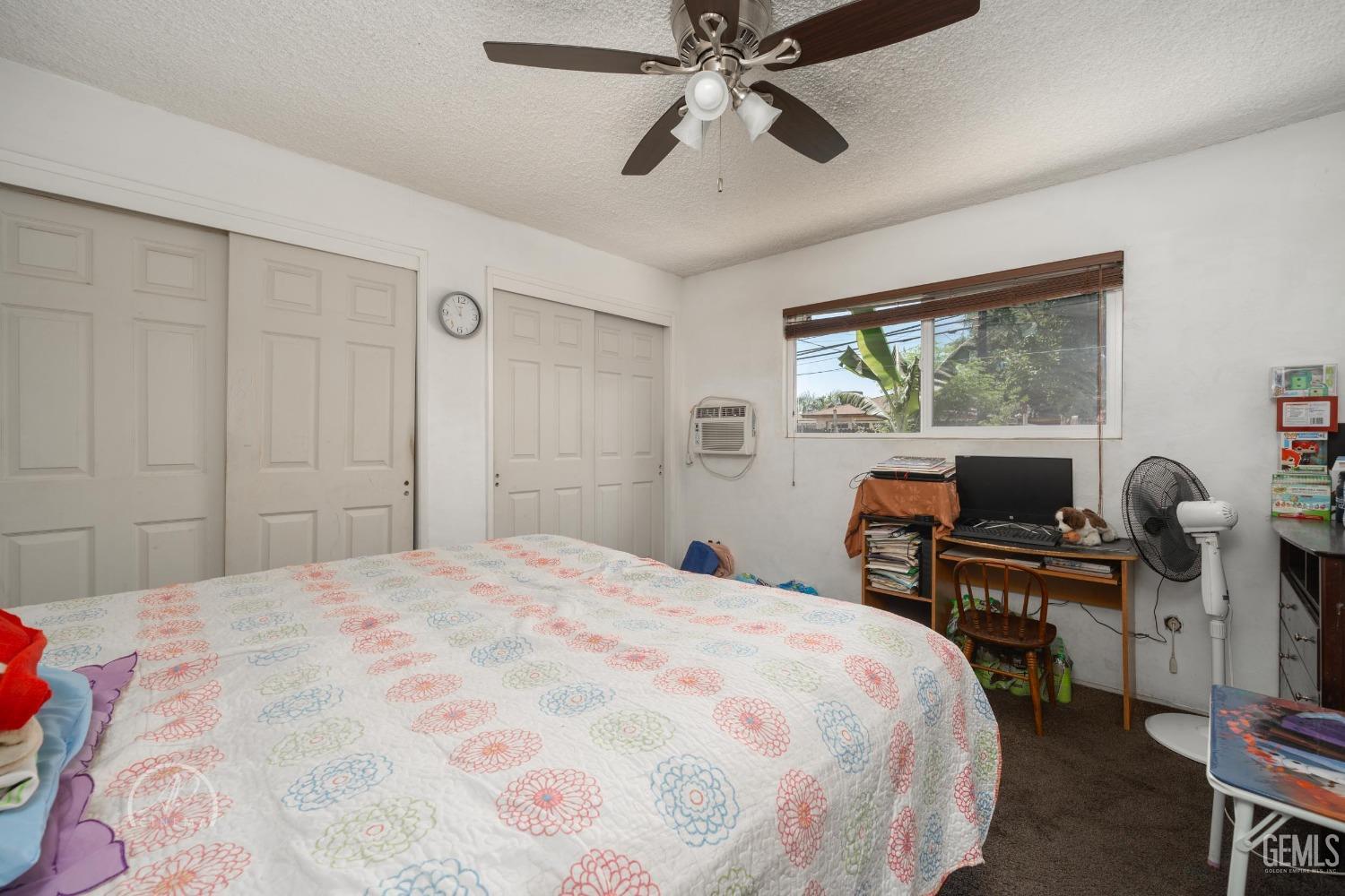 Undisclosed Address Bakersfield, CA 93307 - Photo 10 of 26 a bedroom with a bed and a large window