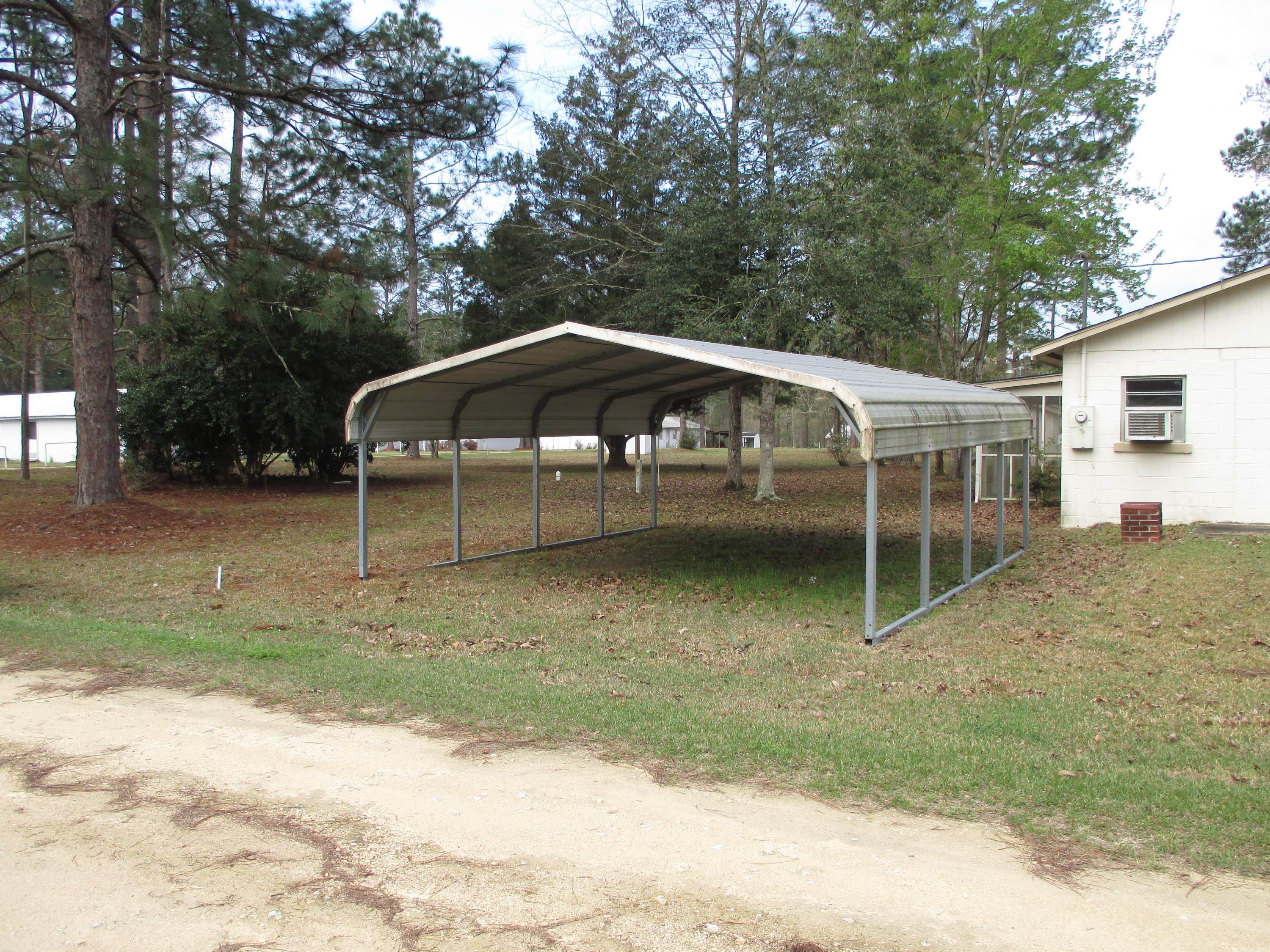 419 Christian Life Road DeFuniak Springs, FL 32433 - Photo 5 of 9 a backyard of a house with table and chairs