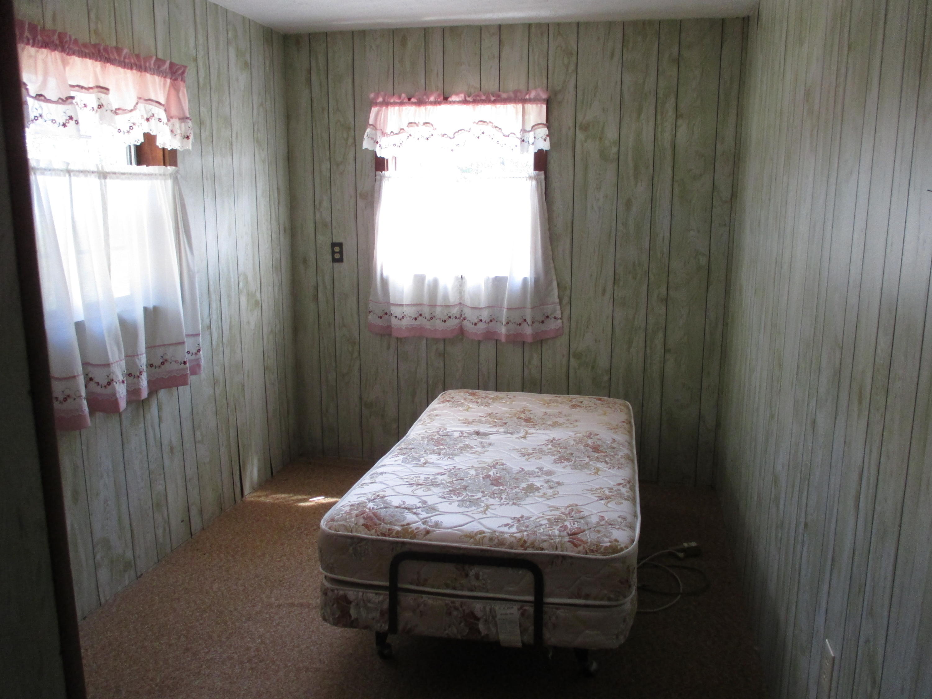 419 Christian Life Road DeFuniak Springs, FL 32433 - Photo 7 of 9 a bed sitting in a bedroom next to a window