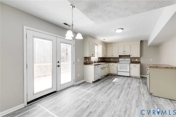 a view of kitchen with wooden floor