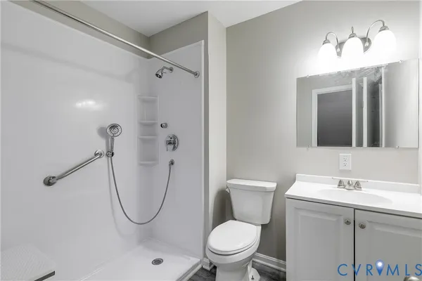 a bathroom with a toilet sink shower and mirror