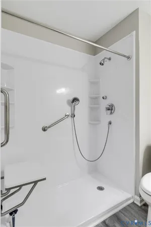 a bathroom with a shower a toilet and a shower