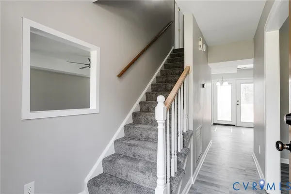 a view of a hallway with wooden floor and entryway