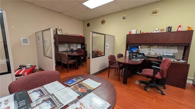 a living room filled with furniture and a wooden floor