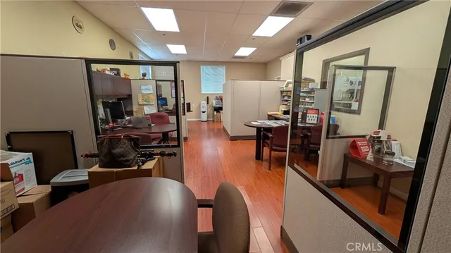 a view of a livingroom with furniture hardwood floor and a large window
