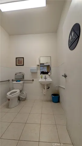 a bathroom with a toilet a sink and a view