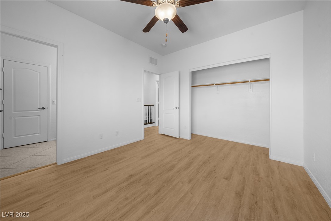 10059 Lady Apple Drive Las Vegas, NV 89148 - Photo 11 of 31 Unfurnished bedroom with light wood finished floors and ceiling fan