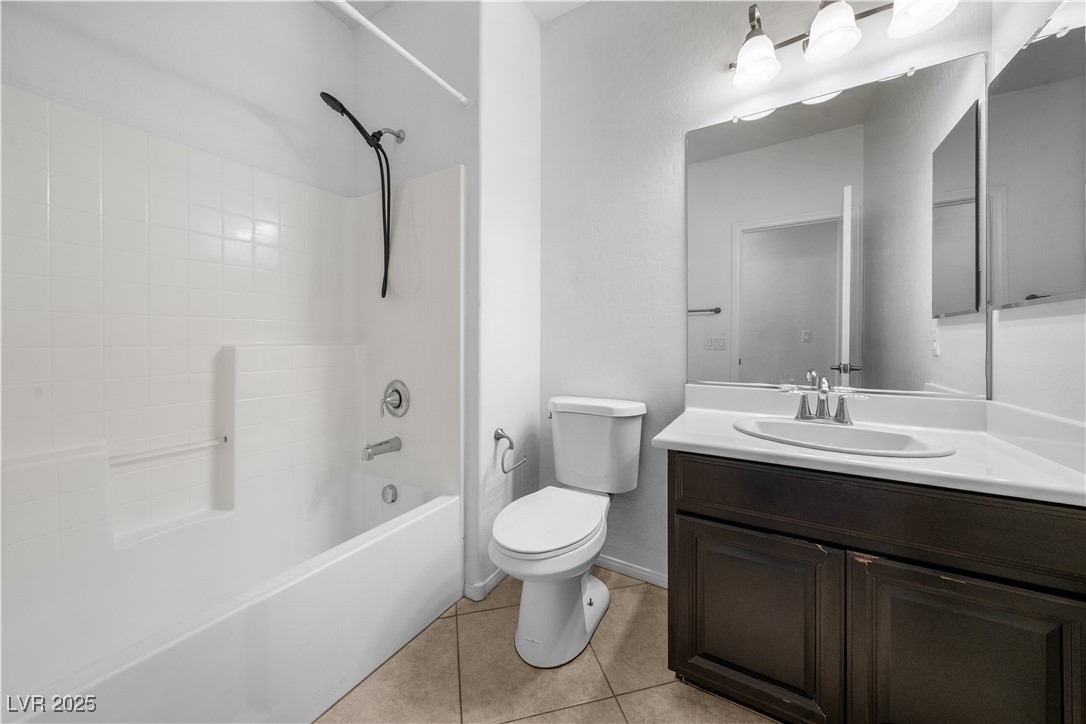 10059 Lady Apple Drive Las Vegas, NV 89148 - Photo 12 of 31 Bathroom featuring vanity, tub / shower combination, and light tile patterned floors