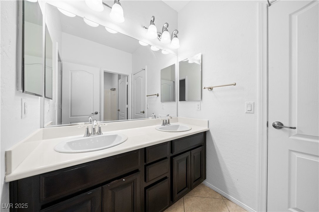 10059 Lady Apple Drive Las Vegas, NV 89148 - Photo 14 of 31 Bathroom with double vanity and light tile patterned floors