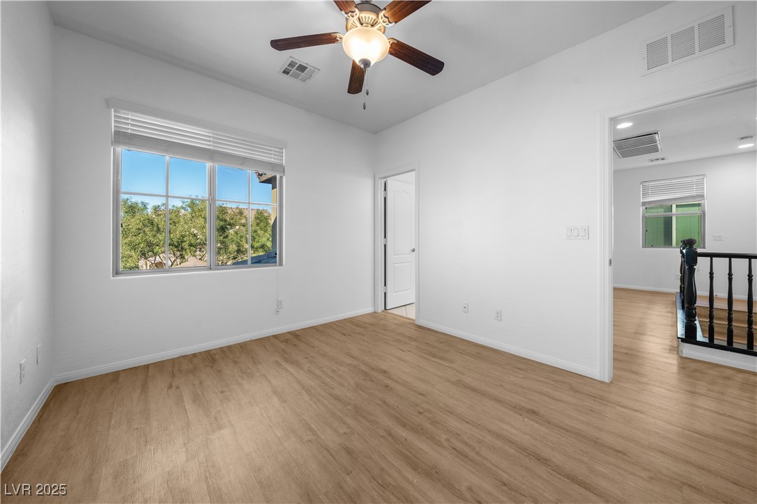 10059 Lady Apple Drive Las Vegas, NV 89148 - Photo 22 of 31 Spare room with light wood finished floors, a ceiling fan, and plenty of natural light