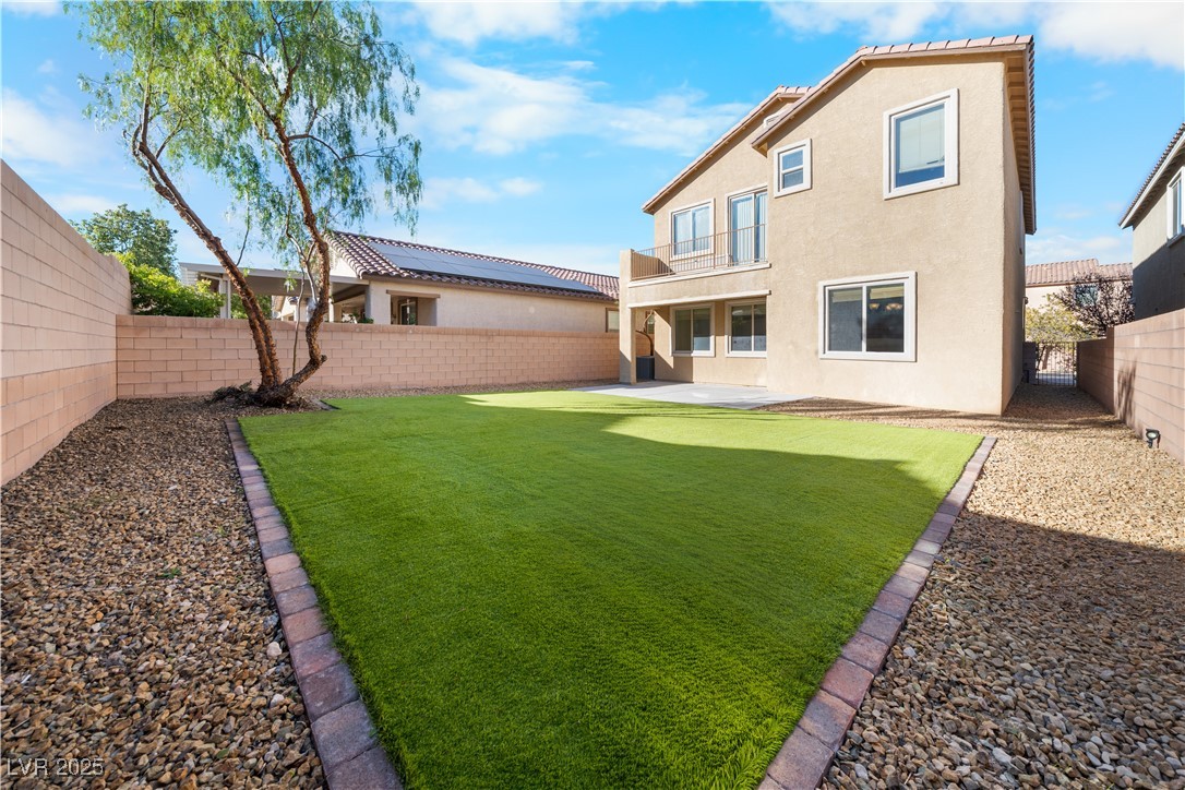 10059 Lady Apple Drive Las Vegas, NV 89148 - Photo 26 of 31 Rear view of property with a fenced backyard, a patio area, stucco siding, and a balcony
